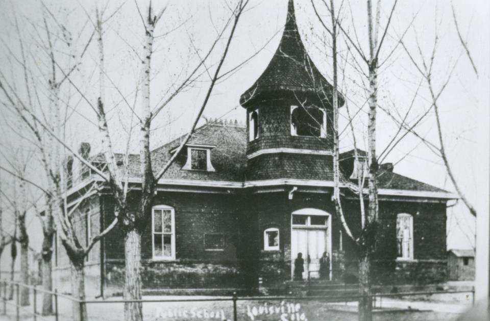 black and white image of the Louisville Art Center, a red brick building with a pointed cupola
