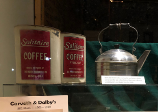 Two vintage coffee tins that read "Solitaire Coffee" and a tin tea pot