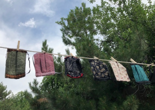 Colorful cloth masks hang on a laundry line
