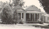 Historic photo of a home with a large front porch