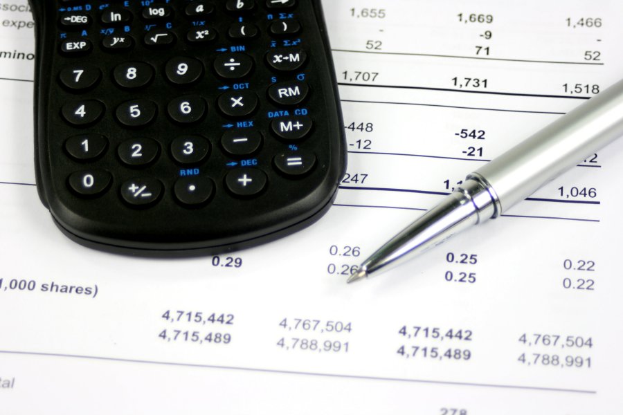 a calculator and pen on paper with numbers on it