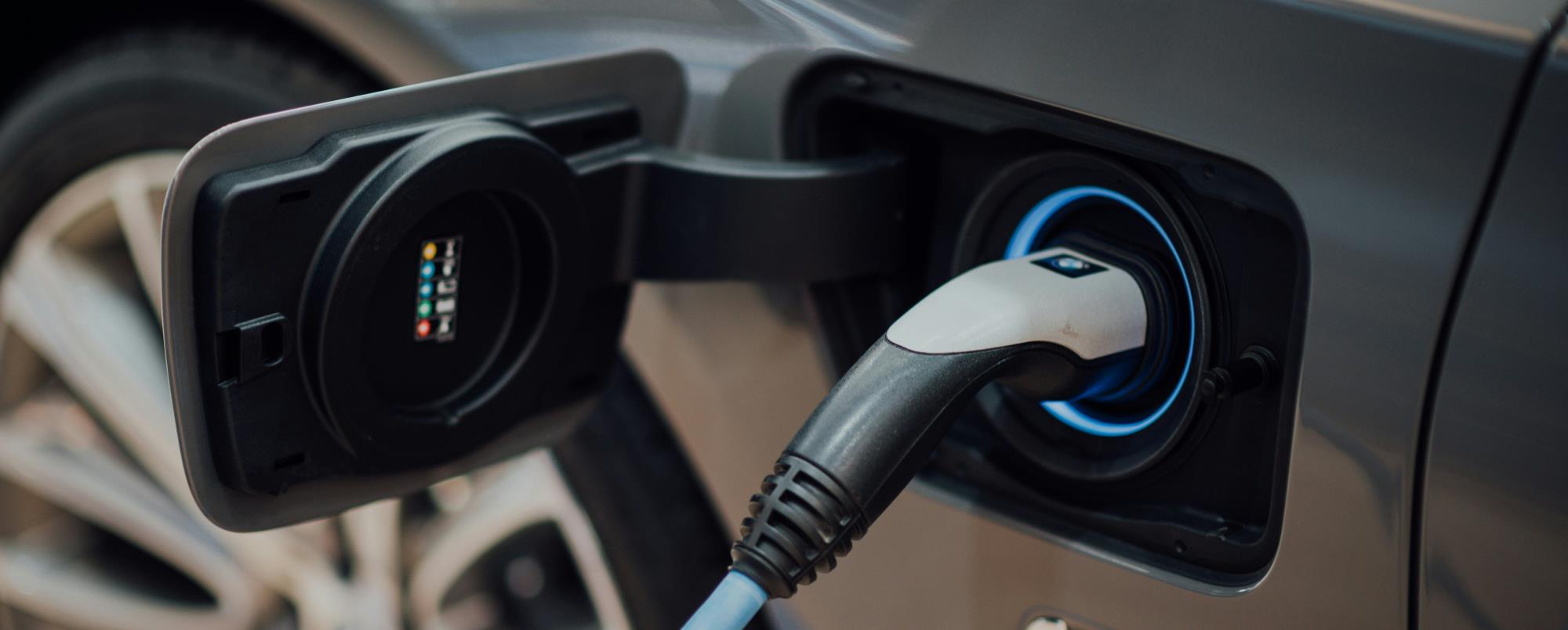Electric vehicle charger plugged into an electric vehicle.