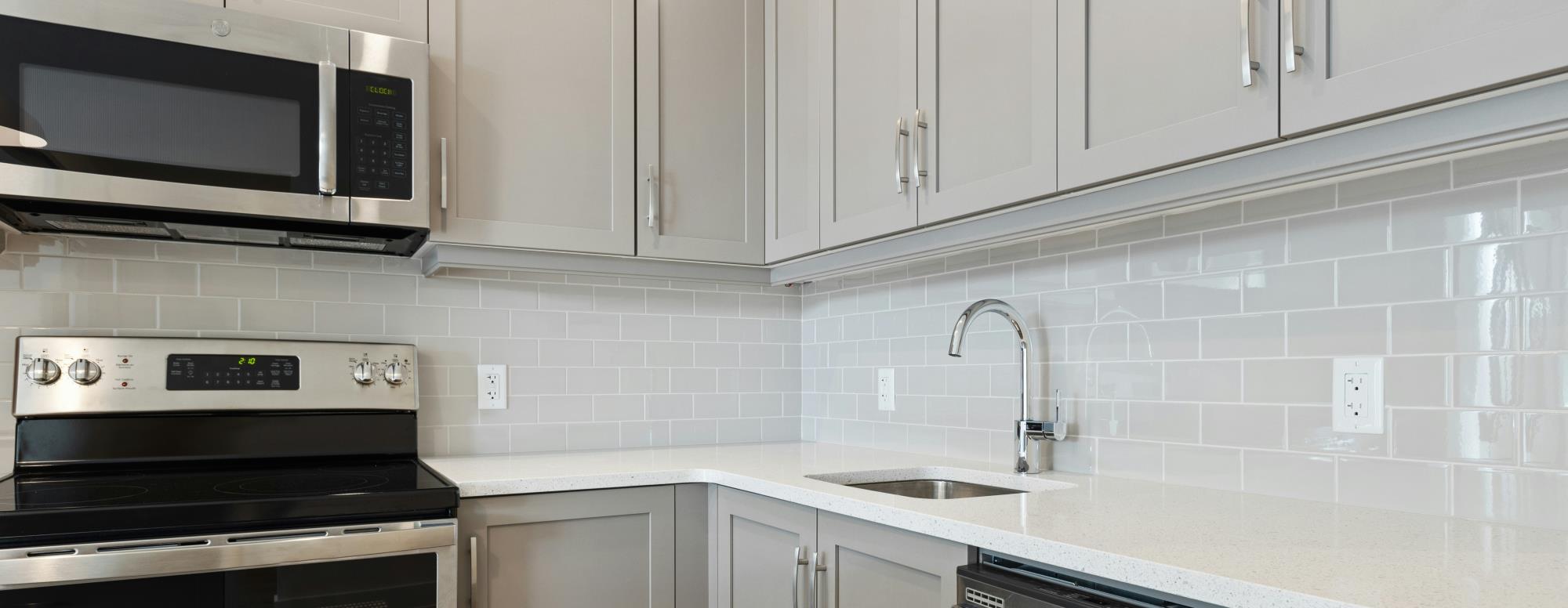 White kitchen with electric appliances.