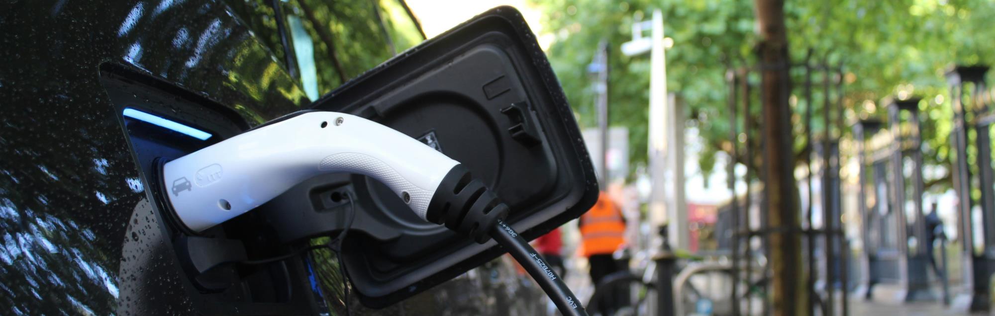 Electric vehicle charger plugged into an electric vehicle.